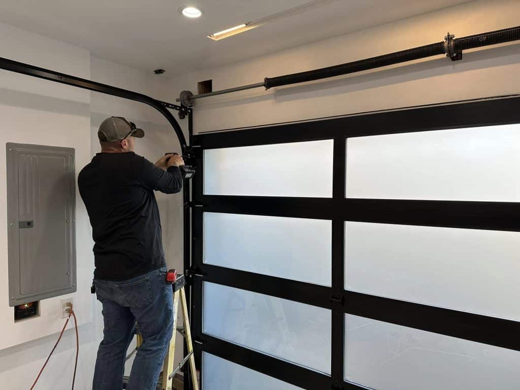 man installing a new garage door